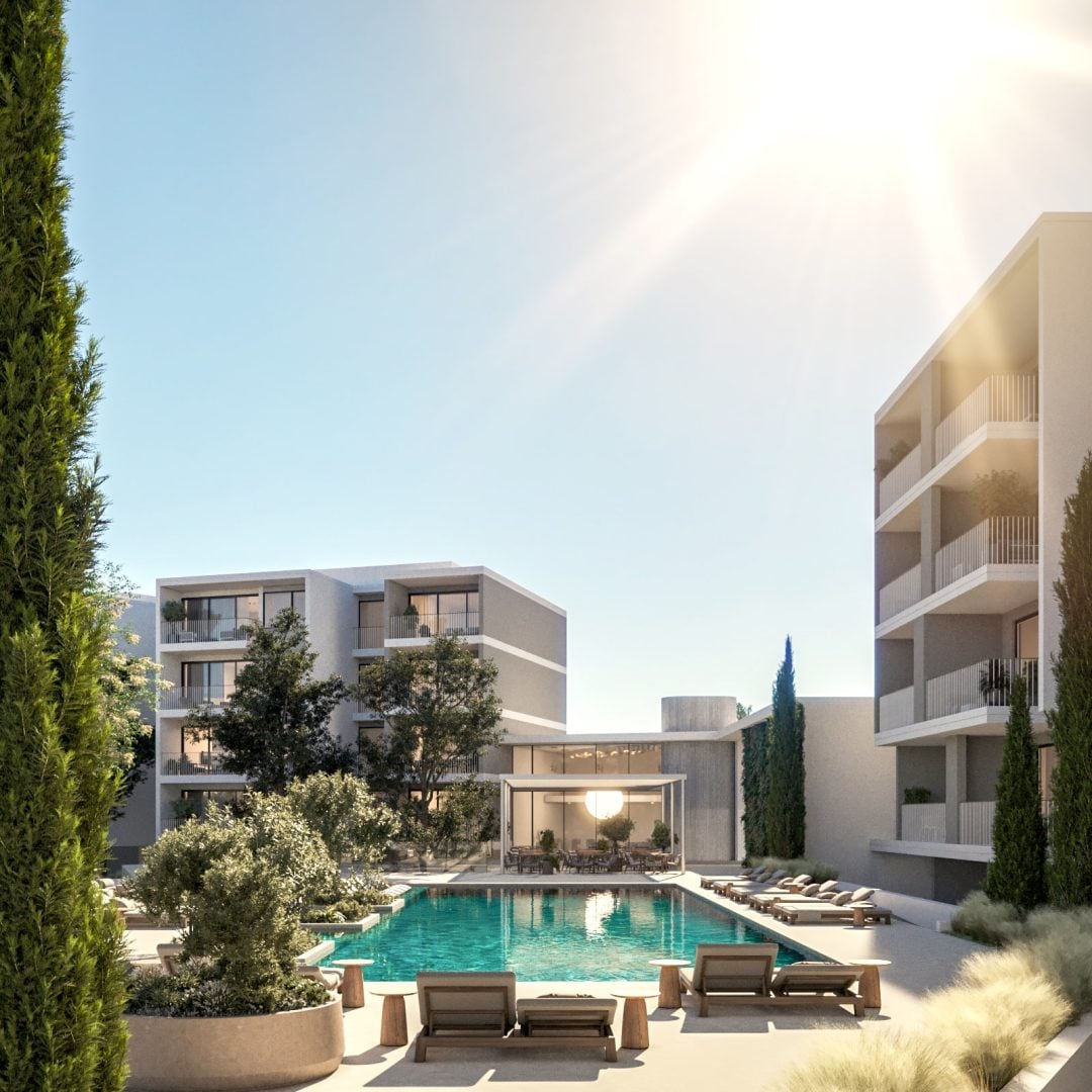 09 Pool Hero View-min - Sovereign Estates Sovereign Estates Modern apartment complex with a central rectangular pool surrounding lounge chairs and a glass wrapped community pavilion under a bright sky 2026 Modern apartment complex with a central rectangular pool surrounding lounge chairs and a glass wrapped community pavilion under a bright sky