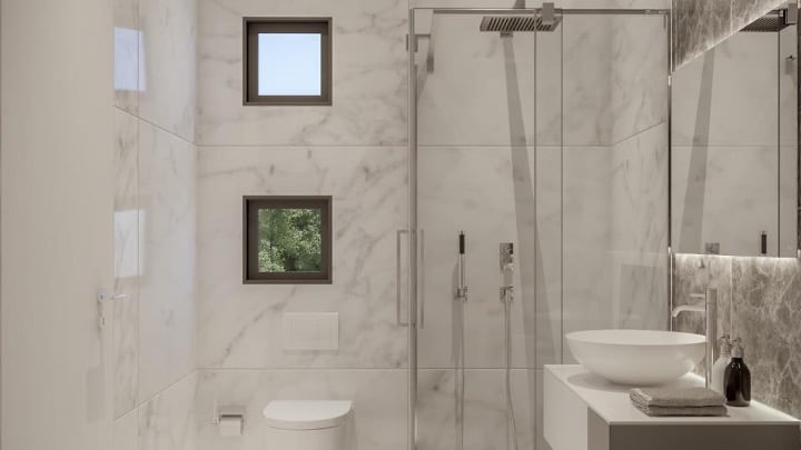 4-Lana-Villa-Bathroomjpg - Sovereign Estates Sovereign Estates Modern marble bathroom with glass shower enclosure wall mounted vanity with a bowl sink and two small square windows 2026 Modern marble bathroom with glass shower enclosure wall mounted vanity with a bowl sink and two small square windows
