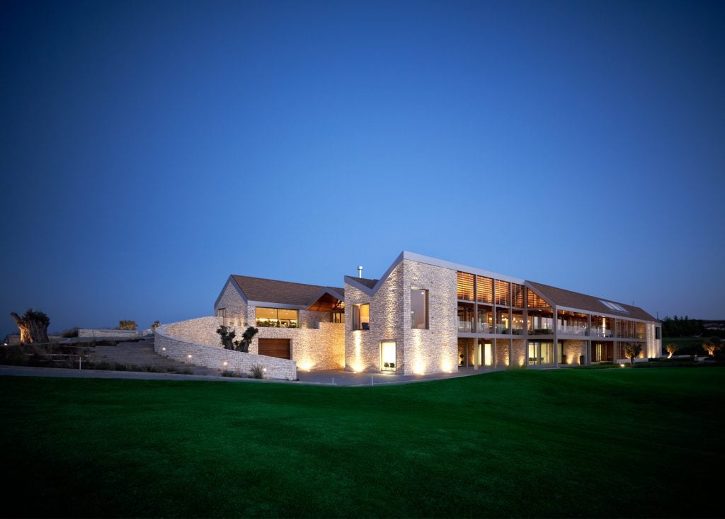 BClubhouse-1024x733jpg - Sovereign Estates Sovereign Estates Modern stone house at dusk with warm interior lights and a well manicured green lawn nearby 2026 Modern stone house at dusk with warm interior lights and a well manicured green lawn nearby