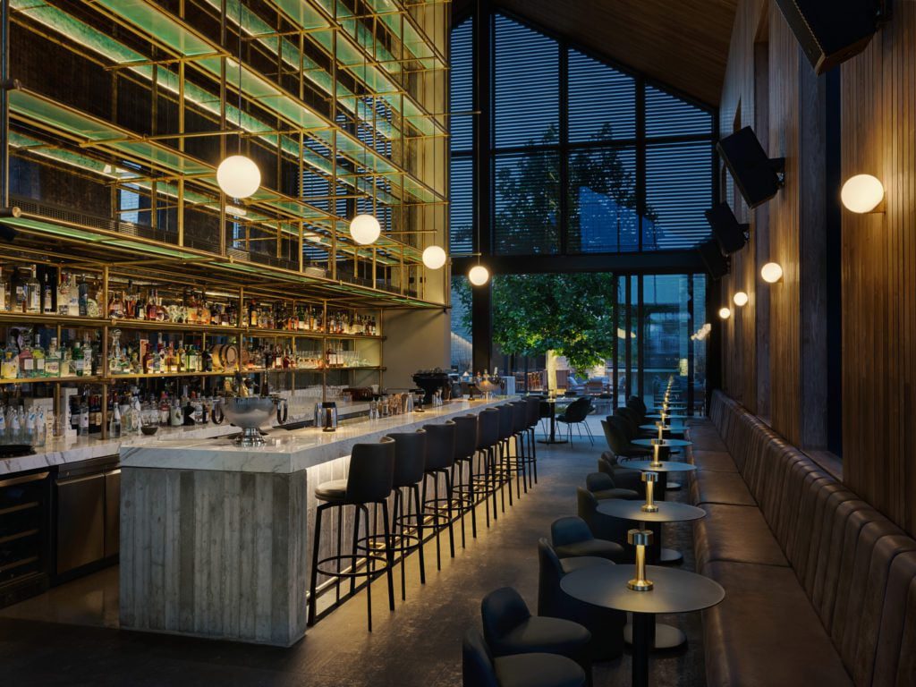 Bar-M-1024x768jpg - Sovereign Estates Sovereign Estates Modern bar interior with a long marble counter black stools and backlit liquor shelves above 2026 Modern bar interior with a long marble counter black stools and backlit liquor shelves above