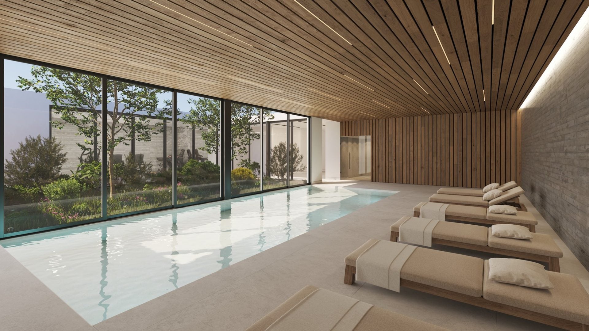 Elysia Blu 4 - Sovereign Estates Sovereign Estates Indoor pool area with floor to ceiling glass walls a garden outside and a row of beige lounge chairs along the right wall The ceiling and walls are clad in warm wooden panels 2026 Indoor pool area with floor to ceiling glass walls a garden outside and a row of beige lounge chairs along the right wall The ceiling and walls are clad in warm wooden panels