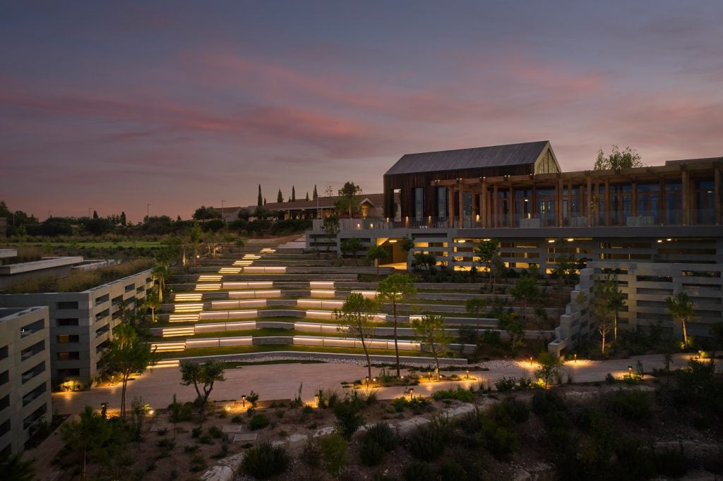 HAmphitheatre-1024x682jpg - Sovereign Estates Sovereign Estates Outdoor terraced amphitheater at dusk with lit steps and a wooden building in the background informative 2026 Outdoor terraced amphitheater at dusk with lit steps and a wooden building in the background informative
