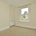Sovereign Estates   A small empty beige room with a window light carpet and a white radiator near the wall 2026 A small empty beige room with a window light carpet and a white radiator near the wall