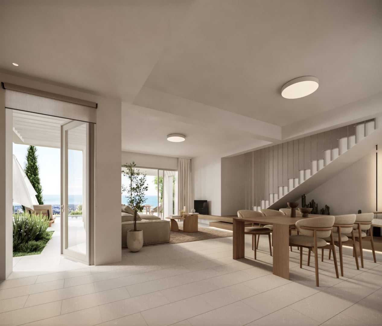 General_View_TA - Sovereign Estates Sovereign Estates Open concept living and dining space with a long wooden table beige chairs and a modern staircase 2026 Open concept living and dining space with a long wooden table beige chairs and a modern staircase