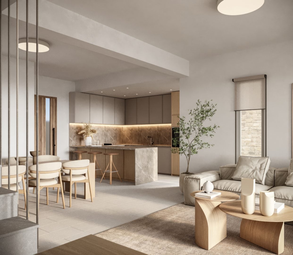 Kitchen_View_TA - Sovereign Estates Sovereign Estates Open concept living space with a beige sofa round wooden coffee table tall plant and a marble kitchen island 2026 Open concept living space with a beige sofa round wooden coffee table tall plant and a marble kitchen island