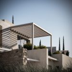 Sovereign Estates   Modern house exterior with a white rectangular pergola over a terrace stone and beige stucco walls and sculpted greenery against a clear blue sky 2026 Modern house exterior with a white rectangular pergola over a terrace stone and beige stucco walls and sculpted greenery against a clear blue sky