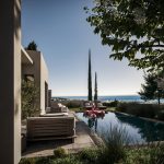 Sovereign Estates   Luxurious outdoor pool area with beige seating planters and a view of the ocean under a clear blue sky 2026 Luxurious outdoor pool area with beige seating planters and a view of the ocean under a clear blue sky