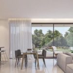 Sovereign Estates   Open concept living and dining area with a large glass wall showing a green garden outside at the patio 2026 Open concept living and dining area with a large glass wall showing a green garden outside at the patio