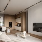 Sovereign Estates   Open plan living room and kitchen with warm wood cabinets white seating round coffee table and a wall mounted TV on the right 2026 Open plan living room and kitchen with warm wood cabinets white seating round coffee table and a wall mounted TV on the right