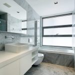 Sovereign Estates   Modern marble bathroom with white vanity square vessel sink large mirror and glass panel tub adjacent to a large window 2026 Modern marble bathroom with white vanity square vessel sink large mirror and glass panel tub adjacent to a large window