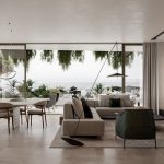 Sovereign Estates   Open living and dining area with floor to ceiling windows showing a coastal city view beige sofa green chairs and a wall TV 2026 Open living and dining area with floor to ceiling windows showing a coastal city view beige sofa green chairs and a wall TV