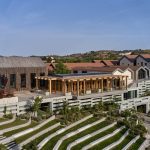 Sovereign Estates   A modern multi level hillside campus with a wooden pergola stone and gray buildings and terraced landscaping 2026 A modern multi level hillside campus with a wooden pergola stone and gray buildings and terraced landscaping