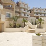 Sovereign Estates   Courtyard of a beige apartment building with curved stairs white railings palm trees and a bright blue sky 2026 Courtyard of a beige apartment building with curved stairs white railings palm trees and a bright blue sky