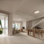 Sovereign Estates   Open concept living and dining area with a long wooden table beige chairs and stairs overlooking a patio with sea view 2026 Open concept living and dining area with a long wooden table beige chairs and stairs overlooking a patio with sea view