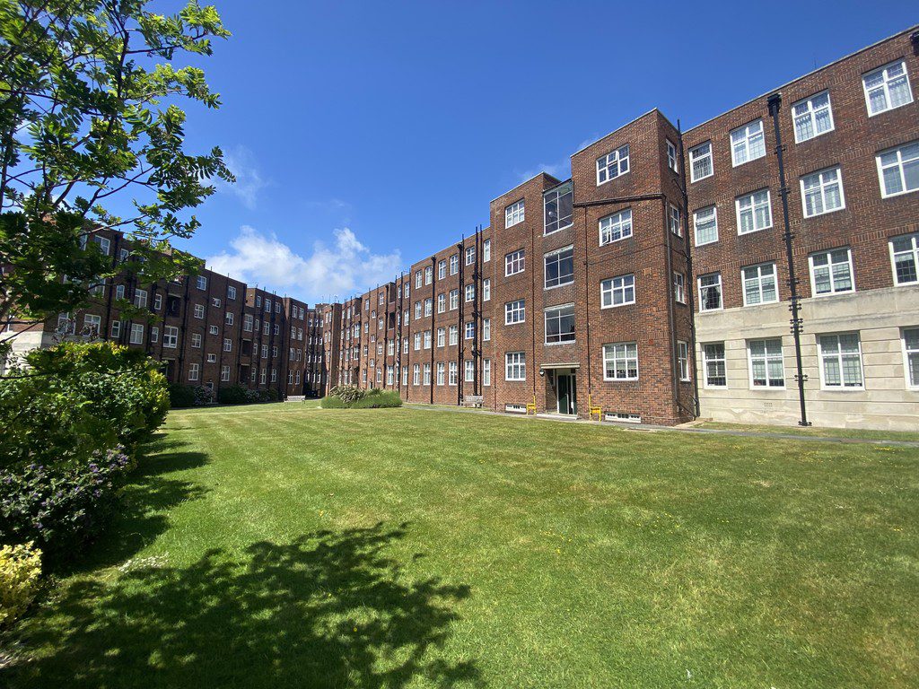 IMG_21_15_largejpg - Sovereign Estates Sovereign Estates Red brick apartment complex with a central grassy courtyard and clear blue sky above 2026 Red brick apartment complex with a central grassy courtyard and clear blue sky above