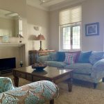 IMG_21_20_largejpg - Sovereign Estates Sovereign Estates A pastel blue living room with patterned sofa and matching chairs around a glass topped coffee table fireplace nearby and large windows letting in light 2026 A pastel blue living room with patterned sofa and matching chairs around a glass topped coffee table fireplace nearby and large windows letting in light
