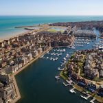 Sovereign Estates   Aerial view of a coastal town with a marina canals and rows of houses along the waterfront 2026 Aerial view of a coastal town with a marina canals and rows of houses along the waterfront