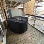 Sovereign Estates   Balcony with a round table covered in a black cloth and a few stones on top overlooking a harbor It shows construction scaffolding nearby 2026 Balcony with a round table covered in a black cloth and a few stones on top overlooking a harbor It shows construction scaffolding nearby