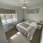 Sovereign Estates   Small double bedroom with white and beige bedding two nightstands and a window letting in daylight 2026 Small double bedroom with white and beige bedding two nightstands and a window letting in daylight
