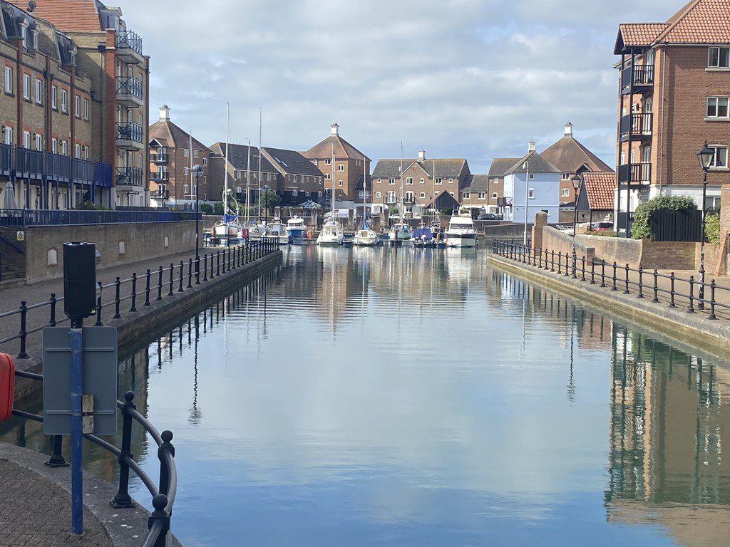 IMG_23_1_largejpg - Sovereign Estates Sovereign Estates Calm canal with boats docked at a marina brick buildings lining both sides and reflections in the water 2026 Calm canal with boats docked at a marina brick buildings lining both sides and reflections in the water