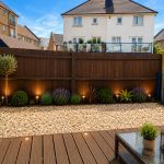 IMG_23_85_largejpg - Sovereign Estates Sovereign Estates Backyard garden with a wooden privacy fence pebble gravel bed and a wooden deck with seating and a glass coffee table at dusk 2026 Backyard garden with a wooden privacy fence pebble gravel bed and a wooden deck with seating and a glass coffee table at dusk