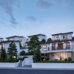 Sovereign Estates   Contemporary white townhouse complex on a gentle slope with glass doors balconies and landscaped gardens at dusk 2026 Contemporary white townhouse complex on a gentle slope with glass doors balconies and landscaped gardens at dusk