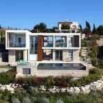 Sovereign Estates   Modern hillside villa with white and stone exterior glass walls and a rectangular pool on a terraced stone terrace 2026 Modern hillside villa with white and stone exterior glass walls and a rectangular pool on a terraced stone terrace