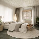 Sovereign Estates   Neutral modern bedroom with white bedding round woven rug and balcony door with wooden slats outside 2026 Neutral modern bedroom with white bedding round woven rug and balcony door with wooden slats outside