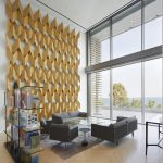 Sovereign Estates   Modern lobby with a large geometric wooden wall sculpture next to a glass bookshelf and seating area by floor to ceiling windows overlooking the ocean 2026 Modern lobby with a large geometric wooden wall sculpture next to a glass bookshelf and seating area by floor to ceiling windows overlooking the ocean
