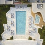 Sovereign Estates   Aerial view of a modern rooftop pool area with a long rectangular blue pool white marble deck and lounge chairs around it 2026 Aerial view of a modern rooftop pool area with a long rectangular blue pool white marble deck and lounge chairs around it