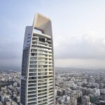 Sovereign Estates   Tall modern skyscraper with a rounded top arch rising above a dense cityscape 2026 Tall modern skyscraper with a rounded top arch rising above a dense cityscape