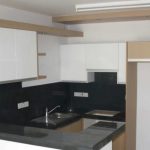 Sovereign Estates   Modern L shaped kitchen with white upper cabinets wood tone accents black backsplash and gray countertops sink and stove visible 2026 Modern L shaped kitchen with white upper cabinets wood tone accents black backsplash and gray countertops sink and stove visible