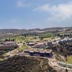 Sovereign Estates   Aerial view of a hillside resort with modern low rise buildings manicured lawns and winding roads under a blue sky 2026 Aerial view of a hillside resort with modern low rise buildings manicured lawns and winding roads under a blue sky