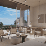 Sovereign Estates   Bright living area with floor to ceiling glass doors opening to a sunny outdoor space and a coastal landscape beyond Beige seating round rug and a wooden dining table create a minimalist modern look 2026 Bright living area with floor to ceiling glass doors opening to a sunny outdoor space and a coastal landscape beyond Beige seating round rug and a wooden dining table create a minimalist modern look