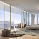 Sovereign Estates   Luxurious bedroom with floor to ceiling glass walls overlooking the ocean a low platform bed and a seating area 2026 Luxurious bedroom with floor to ceiling glass walls overlooking the ocean a low platform bed and a seating area