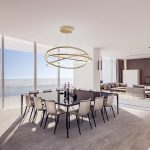 Sovereign Estates   Open plan living and dining area with a circular gold chandelier black dining table and beige chairs facing ocean windows 2026 Open plan living and dining area with a circular gold chandelier black dining table and beige chairs facing ocean windows