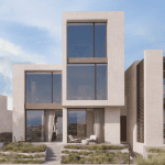 Sovereign Estates   Modern twostory house with large glass windows beige brick facade and a patio with seating amid landscaped steps 2026 Modern twostory house with large glass windows beige brick facade and a patio with seating amid landscaped steps