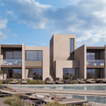 Sovereign Estates   Modern two story beige villa with large glass walls surrounding a pool terrace and lounge chairs 2026 Modern two story beige villa with large glass walls surrounding a pool terrace and lounge chairs