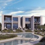 Sovereign Estates   Modern two story apartment building with large glass windows surrounding a curved outdoor pool area and landscaped desert style plants under a blue sky 2026 Modern two story apartment building with large glass windows surrounding a curved outdoor pool area and landscaped desert style plants under a blue sky