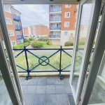 Sovereign Estates   Balcony with blue railing overlooking a grassy courtyard and neighboring brick apartment buildings 2026 Balcony with blue railing overlooking a grassy courtyard and neighboring brick apartment buildings