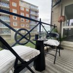 Sovereign Estates   Balcony with two folding chairs and a small round table striped cushions and a view of a brick apartment building beyond the railing 2026 Balcony with two folding chairs and a small round table striped cushions and a view of a brick apartment building beyond the railing