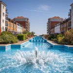 Sovereign Estates   Modern apartment complex with a long central water feature and fountains lined by red brick buildings and green shrubs on both sides 2026 Modern apartment complex with a long central water feature and fountains lined by red brick buildings and green shrubs on both sides