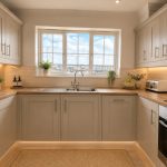IMG_25_47_largejpg - Sovereign Estates Sovereign Estates Bright U shaped kitchen with gray shaker cabinets light wood countertops and a large window over the double sink 2026 Bright U shaped kitchen with gray shaker cabinets light wood countertops and a large window over the double sink